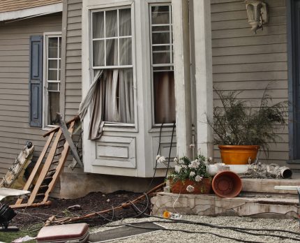 Wooden house damaged by disaster.